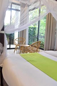 1 dormitorio con 1 cama, mesa y sillas en Golden Ray villa en Anuradhapura