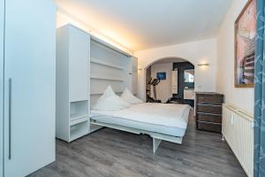 a small bedroom with a bed and a dresser at Mona in Westerland (Sylt)