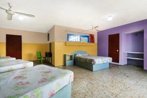 a large room with two beds and a fireplace at OYO Hotel San Martin in Veracruz