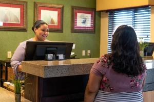 a woman standing at a cash register in a store at Wingate by Wyndham Sioux City in Sioux City +67 photos