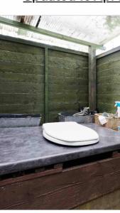 a white sink sitting on top of a table at little vintage caravan with cosy log burner in Canterbury