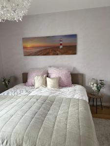 a bedroom with a bed with a lighthouse on the wall at OD Ferienwohnung in Bad Salzuflen