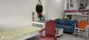 a living room with a couch and a blue sofa at HOMESTAY -NHÀ MẸ KHANG in Cu Chi