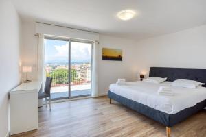 a bedroom with a large bed and a large window at L43 Suite Maurice sea view 6Pax/Terrace,Parking,AC in Saint-Laurent-du-Var