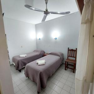 A bed or beds in a room at Posada del Angel