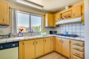 una cocina con armarios amarillos y una ventana en Tranquil Maricopa Retreat with Pool and Hot Tub, en Maricopa