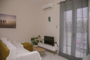 a living room with a couch and a tv at Just A Stay apartement in Chios