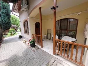 a porch of a house with a balcony at Penzión Korzo in Štúrovo
