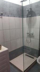 a shower with a glass door in a bathroom at Nice Cosy apartment in Igoumenitsa in Igoumenitsa
