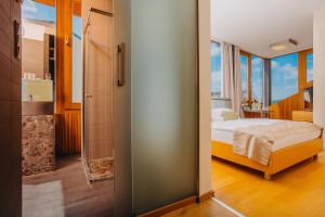 a bedroom with a bed and a bathroom with a shower at Wenceslas Square Hotel - Czech Leading Hotels in Prague +24 photos