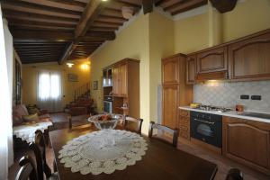 a kitchen with a table and a dining room at Gli Oleandri in Castelfiorentino