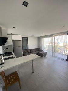 a large living room with a couch and a table at No 22 Residence in Cesme