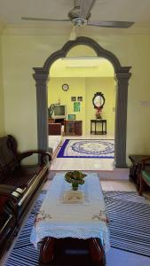 a living room with a table in the middle of a room at Mama Ija Homestay Islamic Arau in Arau