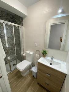 a bathroom with a toilet and a sink and a shower at Piso amplio completo en Almería para 9 personas in Almería