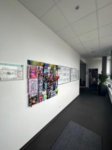 a hallway in an office with posters on the wall at Arena Hostel & Monteurzimmer in Hamburg