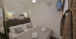 a bedroom with a bed with two scales on it at Soft apartment in Solin next to Split in Solin