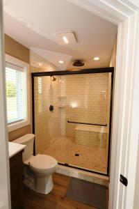 a bathroom with a shower with a toilet and a sink at the evergreene in Fredericktown