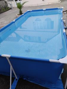 a swimming pool with a blue net around it at Guest house number 1 in Batumi