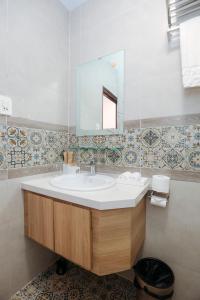 a bathroom with a sink and a mirror at Sweet Lavender Hotel in Da Lat +69 photos