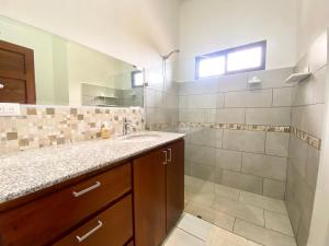 a bathroom with a sink and a shower at Casa Daniela, Cool and Cosy ! in Atenas