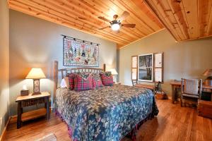 a bedroom with a bed and a wooden ceiling at Badger Ridge in Stone Lake