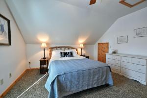 a bedroom with a large bed with a blue blanket at Lost Dutchman in Hayward