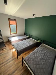 a bedroom with two beds and a window at Domki Platan w Karkonoszach in Kowary