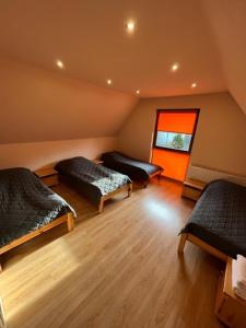 a attic room with two beds and a window at Domki Platan w Karkonoszach in Kowary