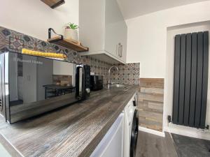 a kitchen with a wooden counter top and a sink at Cristina Modern in Horley