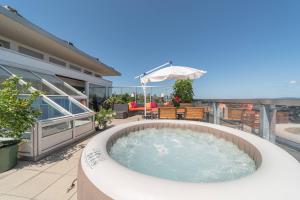 a hot tub on the patio of a house at City Dream Seeblick free parking in Kreuzlingen