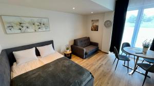 une chambre avec un lit, une table et une chaise dans l'établissement Rising Sun 3 by Housine,pl, à Zator