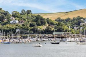 a bunch of boats are docked in a harbor at Harbourside 3 - Luxury Riverside Apartment in Dartmouth