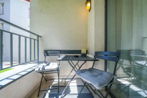 une table et deux chaises assises sur un balcon dans l'établissement My Place Dorobantilor, à Cluj-Napoca