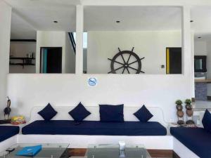 a living room with a blue couch and a wheel on the wall at Casa Apolonia in Guatemala