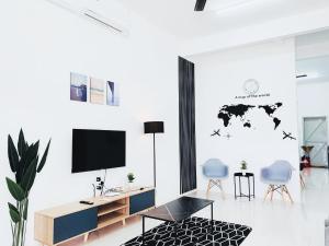 a living room with a world map stenciled on the wall at D' Splash Garden Homestay in Baling