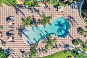 an overhead view of a swimming pool at a resort at Townhouse Near Disney Sleeps 10 Guests & Dog-Friendly! in Kissimmee