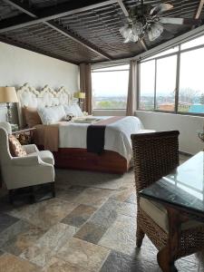 a bedroom with a large bed and a large window at Casa Grande Luxury Boutique Hotel in San Miguel de Allende