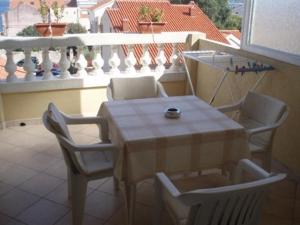 a table and four chairs on a balcony with a table and chairsktop at Apartments Vila&Zora in Vodice