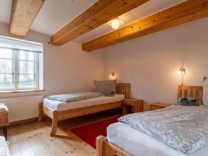 a bedroom with two beds and a window at Holiday home in Westerhever with a fireplace and a beautiful garden in Westerhever