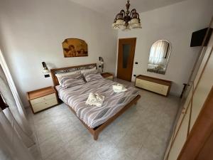 a bedroom with a bed with a dog laying on it at Appartamento Annesca - Delta del Po in Porto Tolle