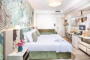 a bedroom with a large white bed and a desk at Life Hotel 4 Superior in Bibione