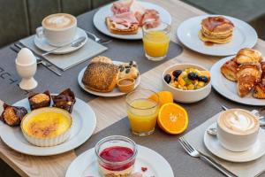 a table topped with plates of breakfast foods and drinks at Life Hotel 4 Superior in Bibione