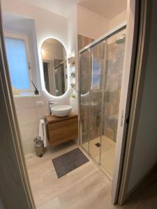 a bathroom with a sink and a shower with a mirror at La Chicca Maison in Vercurago