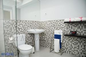 a bathroom with a toilet and a sink at La Mojonera in Isla Plana