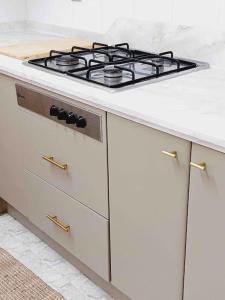 a white kitchen with a stove top on a counter at TORRE DEL MAR DELUXE CLOSE TO BEACH & PARKING Sinese Design Homes in Torre del Mar +18 photos