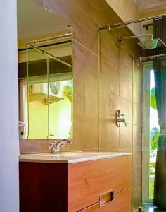a bathroom with a sink and a mirror at Amber Villa Malindi in Malindi