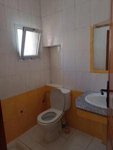 a bathroom with a toilet and a sink at Residence Family OULANTI in Martil