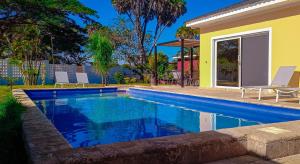 a swimming pool in front of a house at Amber Villa Malindi in Malindi