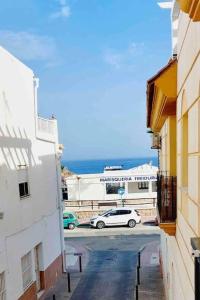 a car parked in a parking lot next to buildings at TORRE DEL MAR DELUXE CLOSE TO BEACH & PARKING Sinese Design Homes in Torre del Mar