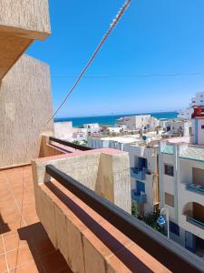 a view of a city from the balcony of a building at Residence Family OULANTI in Martil